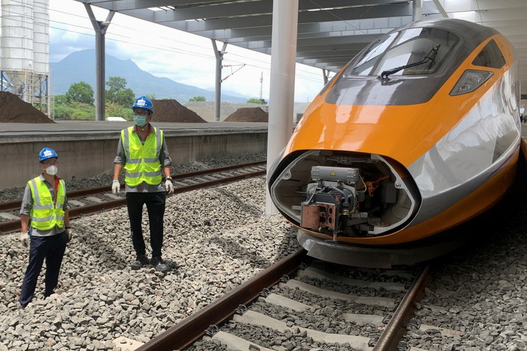 Workers stand beside an Electric Multiple Unit high-speed train for a rail link project that’s part of China's Belt and Road Initiative, at Tegalluar train depot in Bandung, West Java province, Indonesia, Oct. 13, 2022. Credit: Reuters