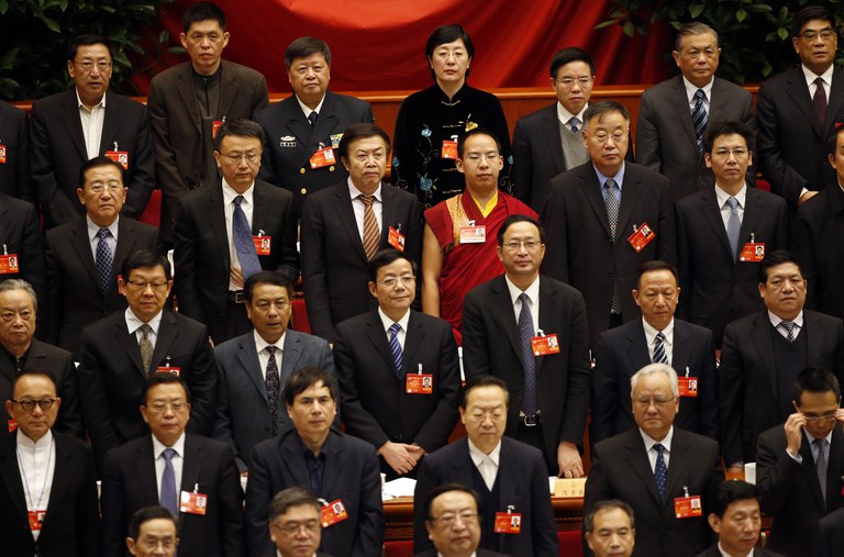 Gyaltsen Norbu [2nd row from top, 3rd R], the 11th Panchen Lama and a delegate of Chinese People's Political Consultative Conference stands with other delegates as they listen to national anthem during the closing ceremony of the CPPCC at the Great Hall of the People in Beijing, March 12, 2014. Credit: Reuters