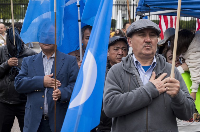 Members of the East Turkistan Awakening Movement sing the East Turkistan national anthem during a rally Oct. 1, 2022, outside the White House against the Chinese Communist Party. Credit: AP