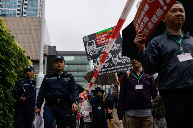Hong Kong police force protesters to wear numbered badges, march in cordon