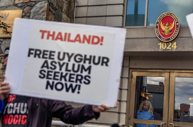 A Uyghur demonstrator holds up a placard outside the Thai embassy in Washington, DC, calling for the release of Uyghur refugees held  in a Thai immigration detention center, May 5, 2023. Credit: RFA/Gemunu Amarasinghe