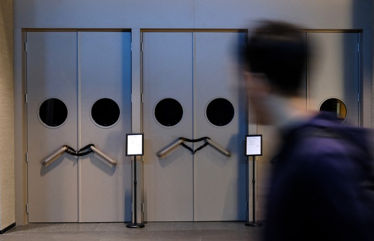 Notice of show cancellations are placed by the locked doors at the show venue of stand-up comedy company Xiaoguo Culture Media Co that has closed its business in Beijing, China May 19, 2023. Tingshu Wang/Reuters