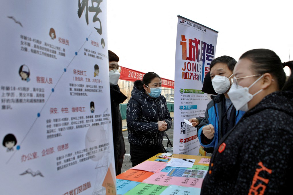 Job seekers visit a booth at a job fair in Beijing, Feb. 16, 2023. Credit: Florence Lo/Reuters