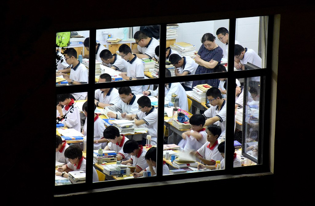 High school students go through exam papers, ahead of the National College Entrance Examinations, known as the gaokao, in Handan, Hebei province, May 17, 2023. Credit: AFP