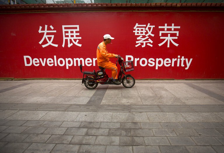 China’s economy is classified as “developing” by a UN report and as “upper-middle income” by the World Bank. Credit: AP