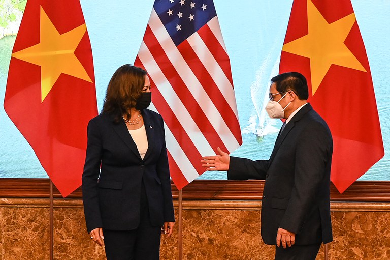 Vietnam's Prime Minister Pham Minh Chinh (R) gestures to U.S. Vice President Kamala Harris in the Government office in Hanoi on August 25, 2021. Credit: Manan Vatsyayana / Pool / AFP