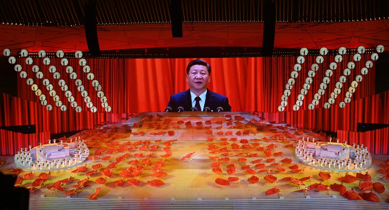A picture of Chinese President Xi Jinping is seen on a large screen during a Cultural Performance as part of the celebration of the 100th Anniversary of the Founding of the Communist Party of China in Beijing on June 28, 2021. Credit: AFP
