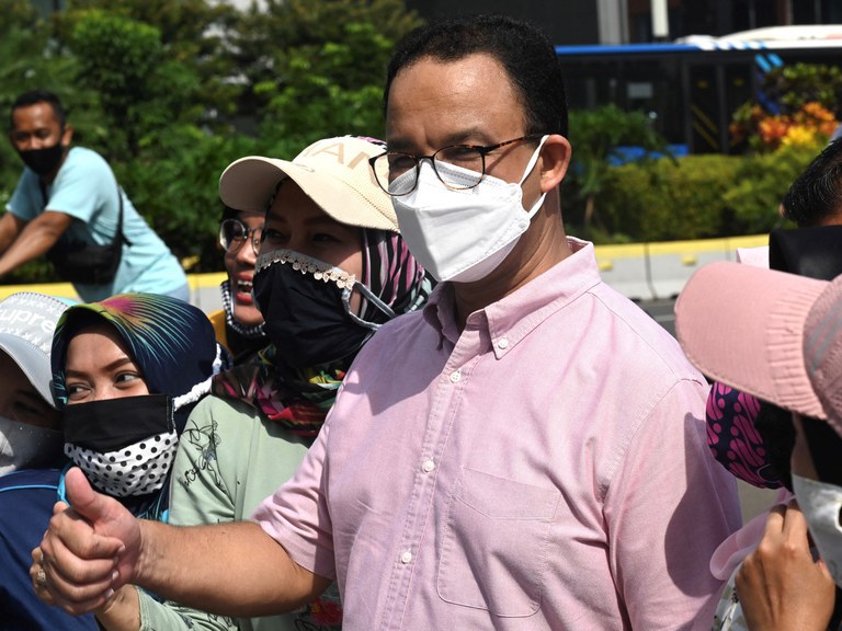 Then-Jakarta Gov. Anies Baswedan poses with residents along a street in Jakarta, Nov. 1, 2020. Credit: Goh Chai Hin/AFP file photo