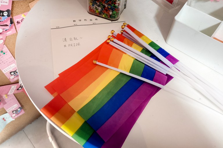 Two students from Tsinghua University in Beijing were harassed after placing 10 rainbow flags on a small table in a campus supermarket in May 2022, leaving a note saying ”'Please take one #PRIDE.” Credit: Courtesy of the interviewees