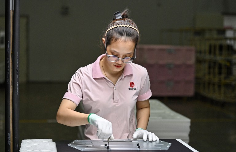 An employee works at Heesung Electronics Vietnam factory in Hai Phong, Vietnam, Aug. 29, 2023. Vietnam’s economy is slowing, with GDP growth of only 3.72% in the first six months of 2023. Credit: Nhac Nguyen/AFP