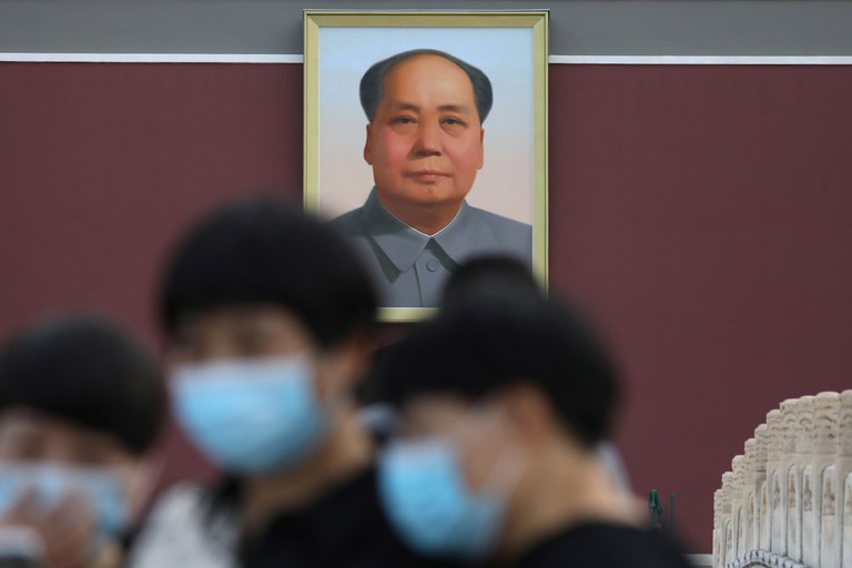 Tourists are seen near a portrait of China's late Chairman Mao Zedong at Tiananmen Square, in Beijing, June 16, 2021. Credit: Tingshu Wang/Reuters