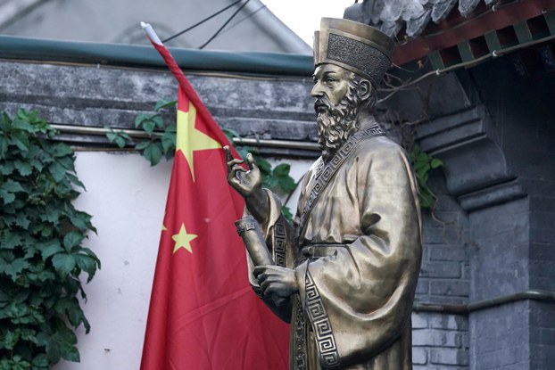 A Chinese flag is seen next to a statue at the entrance of Beijing South Catholic Church, a government-sanctioned Catholic church, in Beijing, Sept. 29, 2018. Credit: Jason Lee/Reuters