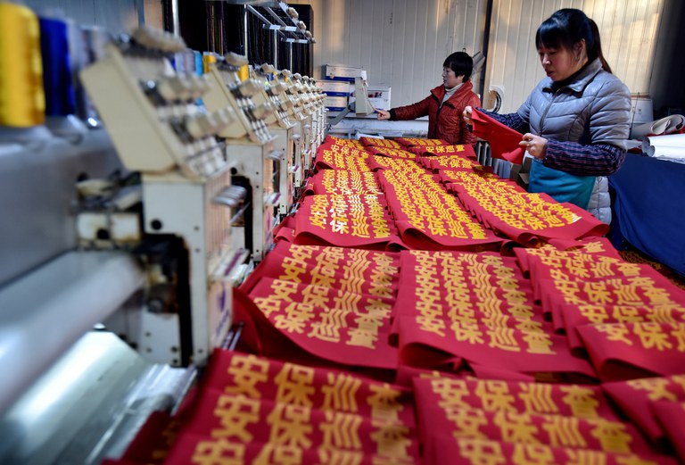 Workers make armbands reading "security patrol" at a garment factory in Zhangjiakou, Hebei province, China, Dec. 5, 2018.  Credit: Reuters