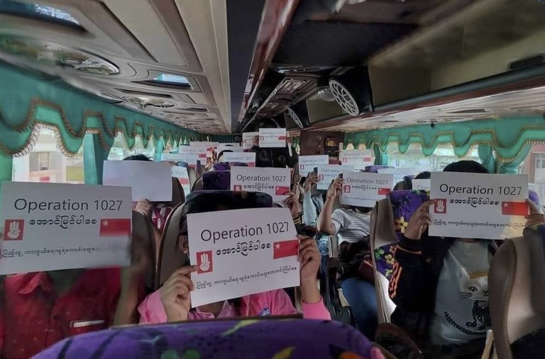 Passengers in a bus display posters in support of the military operation of Myanmar National Democratic Alliance Army. Credit: Citizen journalist