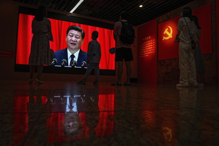 Visitors watch a screen of Chinese President Xi Jinping delivering a speech at an exhibition promoting China's achievement under communist party from 1921 to 2021, in Beijing, June 2021. After the Chinese Communist Party seized power, officials were largely divided into two key categories: those in charge of party governance and those tasked with running the government. Credit: Andy Wong/AP