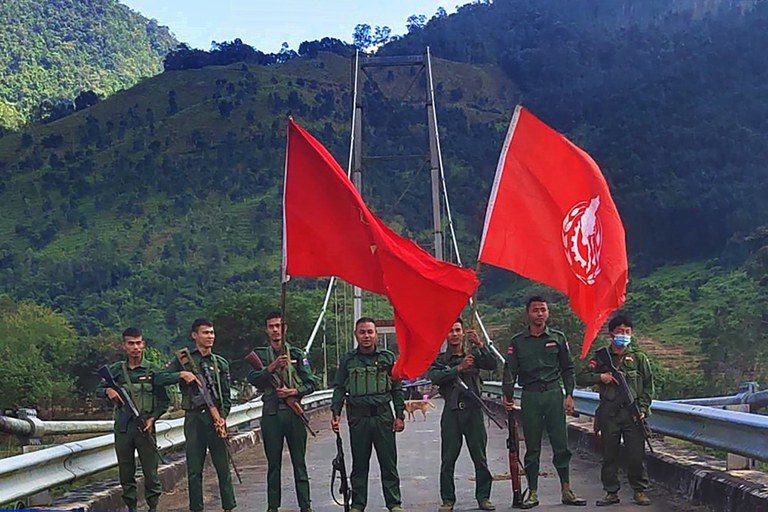 Members of the ethnic rebel group Myanmar National Democratic Alliance Army pose with flags after seizing the Salween bridge near Kunlong town in northern Shan state near the border with China, on Nov. 7, 2023. Credit Credit: Kokang311@ facebook