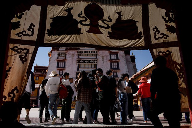 Tourists enter a courtyard of the Potala Palace in Lhasa during a government-organized tour of western China's Tibet Autonomous Region, Oct. 15, 2020. (Thomas Peter/Reuters)
