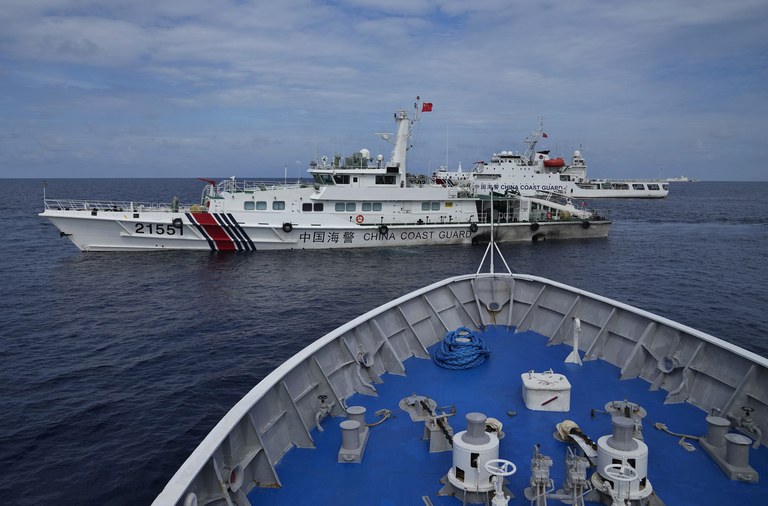 Chinese coast guard ships block Philippine coast guard BRP Cabra as it tried to head towards Second Thomas Shoal at the disputed South China Sea during a rotation and resupply mission on Aug. 22, 2023. (Aaron Favila/AP)