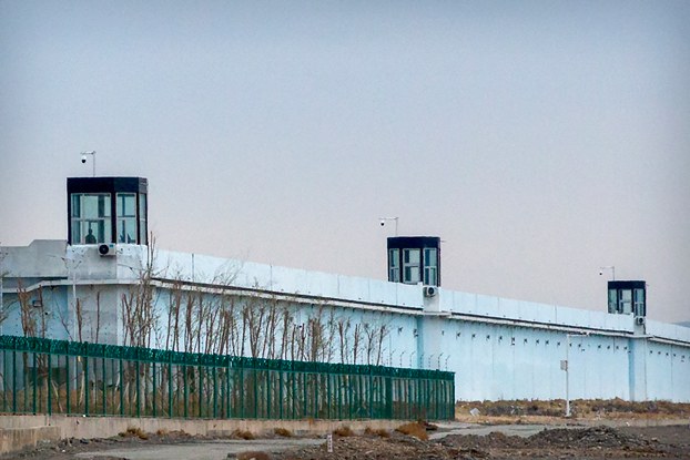 A person stands in a tower on the perimeter of the Number 3 Detention Center in Dabancheng in northwestern China's Xinjiang Uyghur Autonomous Region, April 23, 2021.  (Mark Schiefelbein/AP)
