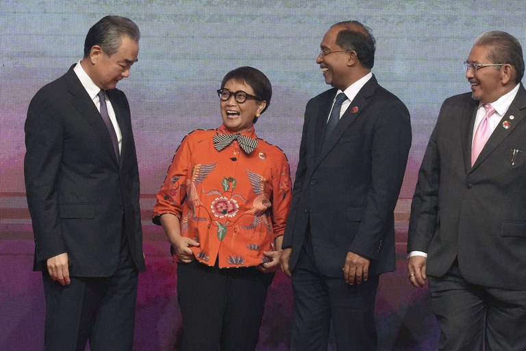 Chinese Communist Party's foreign policy chief Wang Yi shares a light moment with some ASEAN Foreign Ministers during the ASEAN Foreign Ministers' Meeting in Jakarta, Indonesia, July 13, 2023. (Tatan Syuflana/Pool via AP)